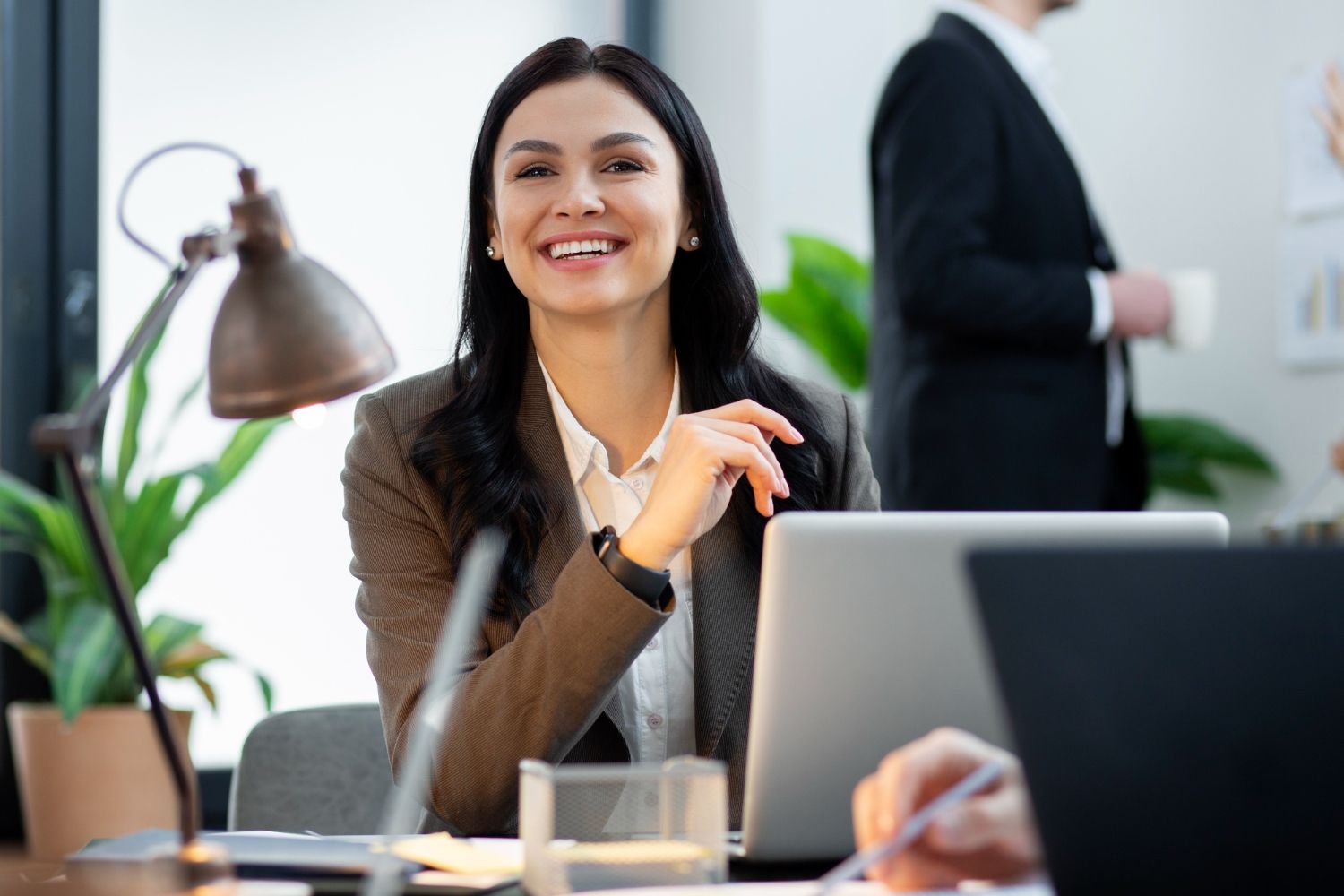 A person looking happy and content at work after engaging in therapy for work-life balance.